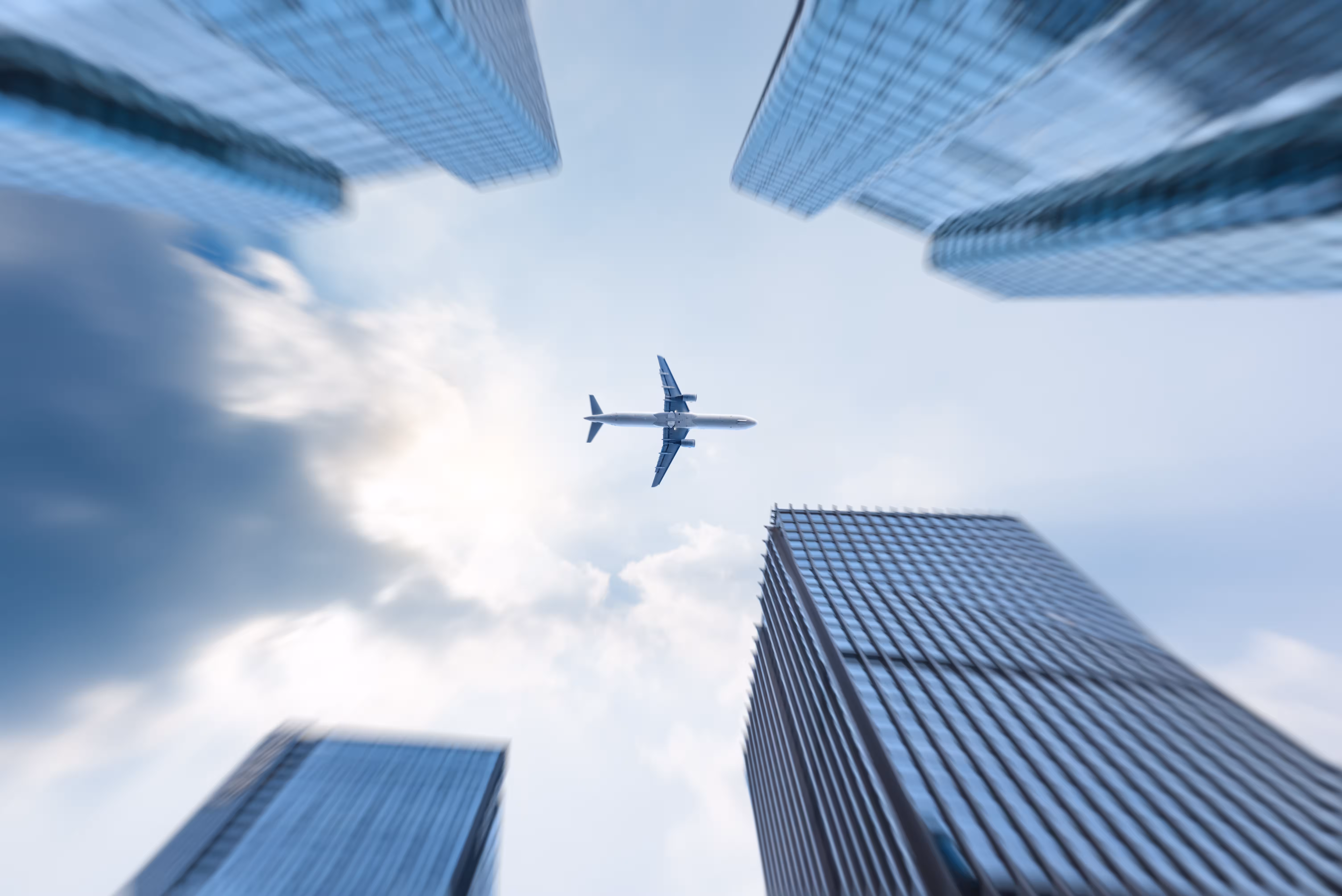 low angle view business buildings with plane flying